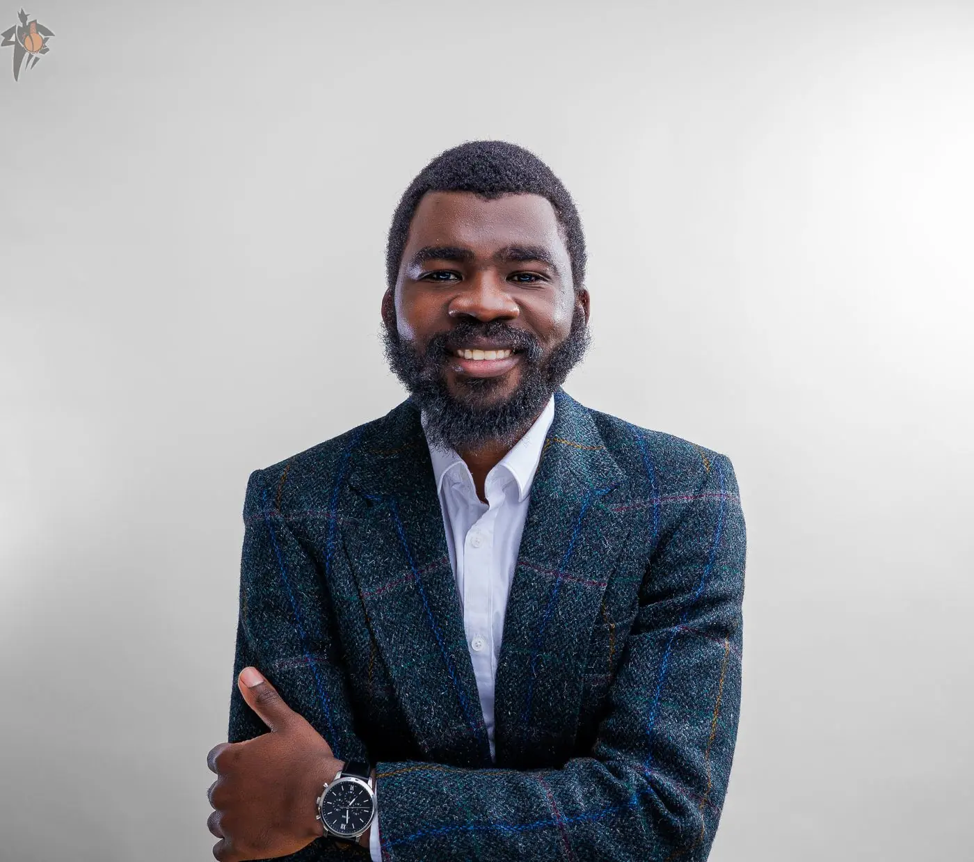 Professional headshot photography in Calgary: man in a tweed blazer against a grey studio backdrop