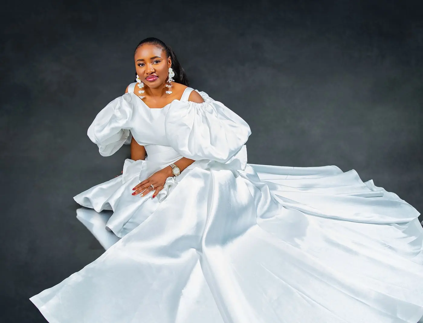 Calgary wedding photography by Onilu Prime: bride in a white satin gown with a full train