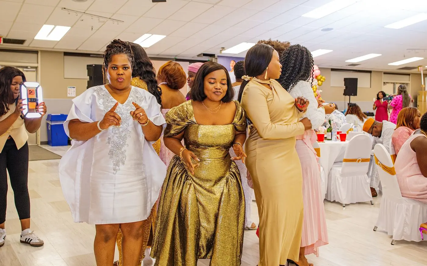 Wedding reception in Calgary: guests dancing in gold and white attire
